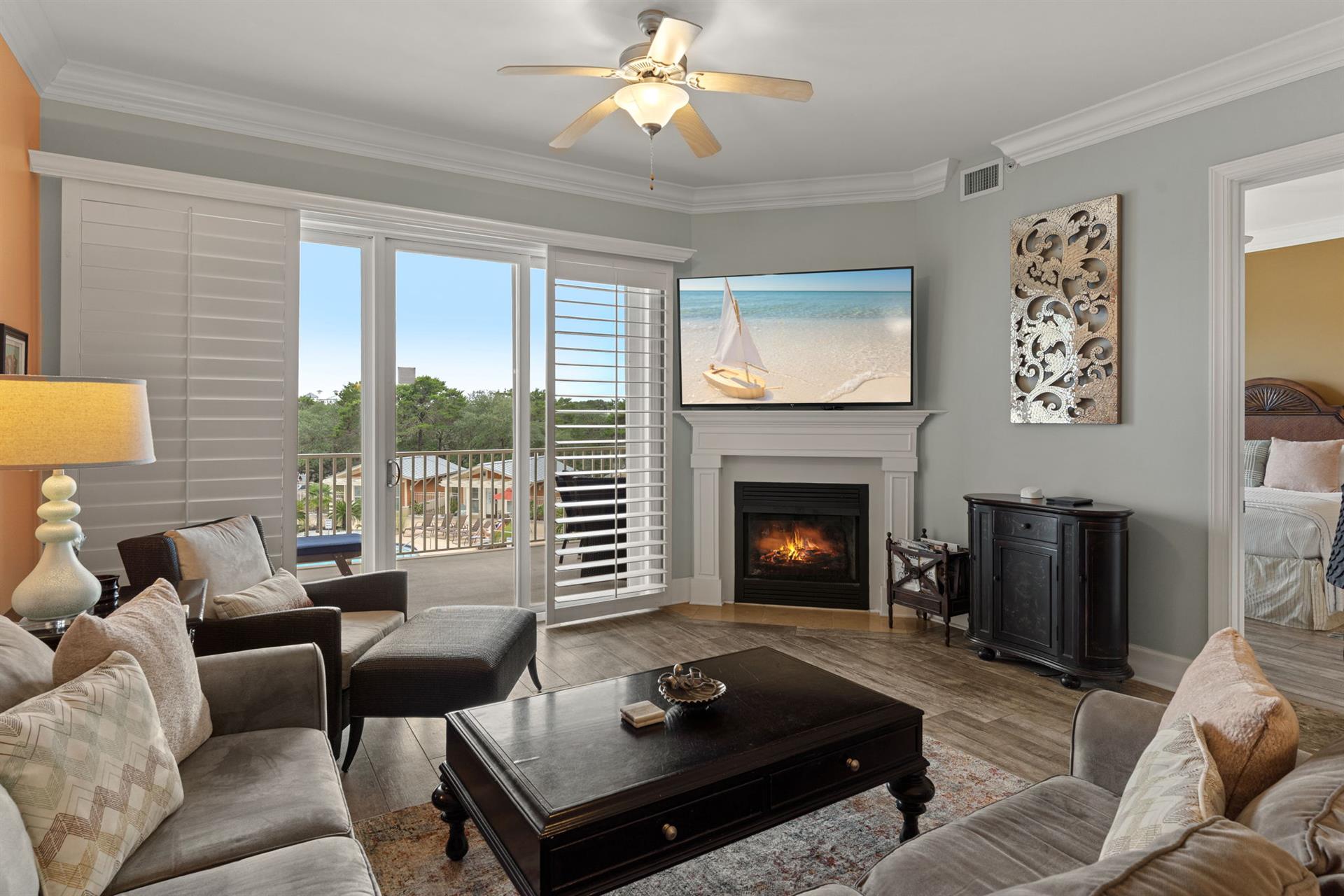 Plush seating surrounds a cozy fireplace and coastal artwork sets the tone. Step through your private balcony doors to soak in peaceful gulf and lake views.