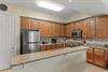 Fully equipped kitchen features rich wood cabinetry, granite countertops, stainless steel appliances, and everything you need to prepare delicious homecooked meals during your stay.