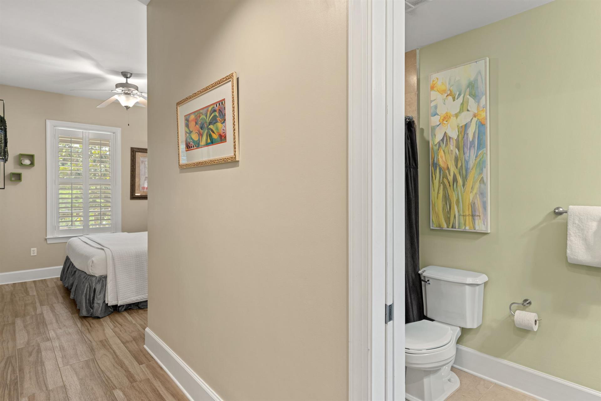 Private king guest suite combines bright, cheerful decor with thoughtful conveniences, a cozy bedroom flows to a fresh, lightfilled bathroom just steps away.