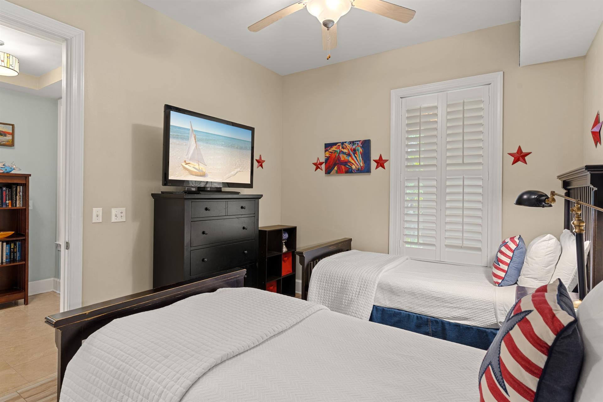 Drift off in this peaceful twin bedroom, where nautical accents and beachthemed decor create a breezy coastal vibe. Relax under the ceiling fans gentle breeze and enjoy your favorite shows on the fl