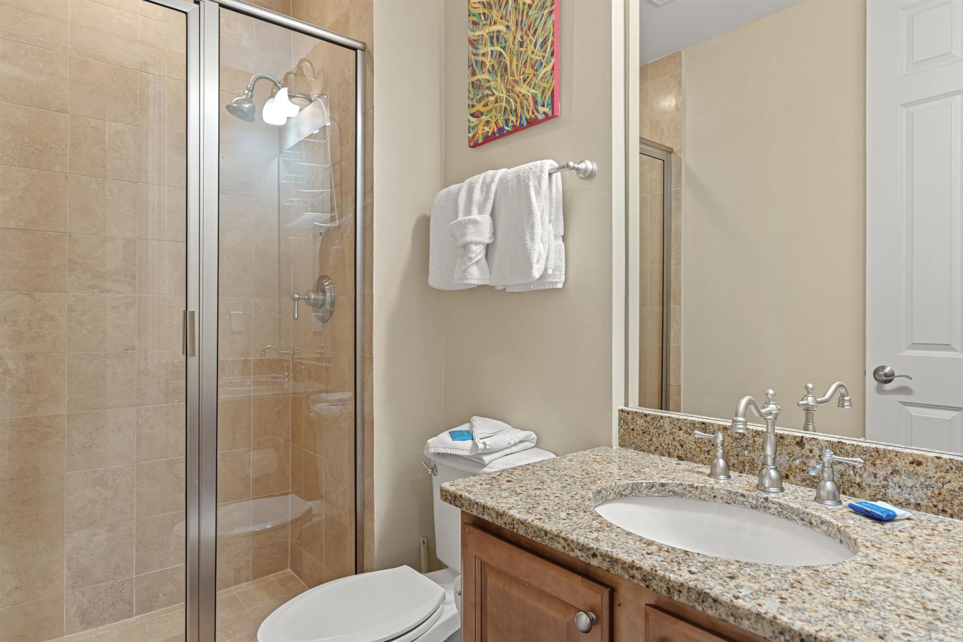 Enjoy the private bathroom with a walkin shower, granite countertops, and fresh towels waiting for you. Ample storage and modern fixtures make freshening up a breeze.