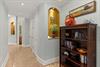 Step into this private retreat through this elegant hallway featuring tasteful décor, builtin alcoves with warm lighting, and thoughtful touches that make you feel at home from the moment you arrive.