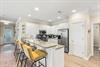 Your spacious kitchen features granite counters, stainless appliances, and a breakfast bar perfect for casual meals or morning coffee together.