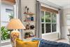 Settle into this cozy corner where natural light streams through windows inviting you to unwind with your favorite book.
