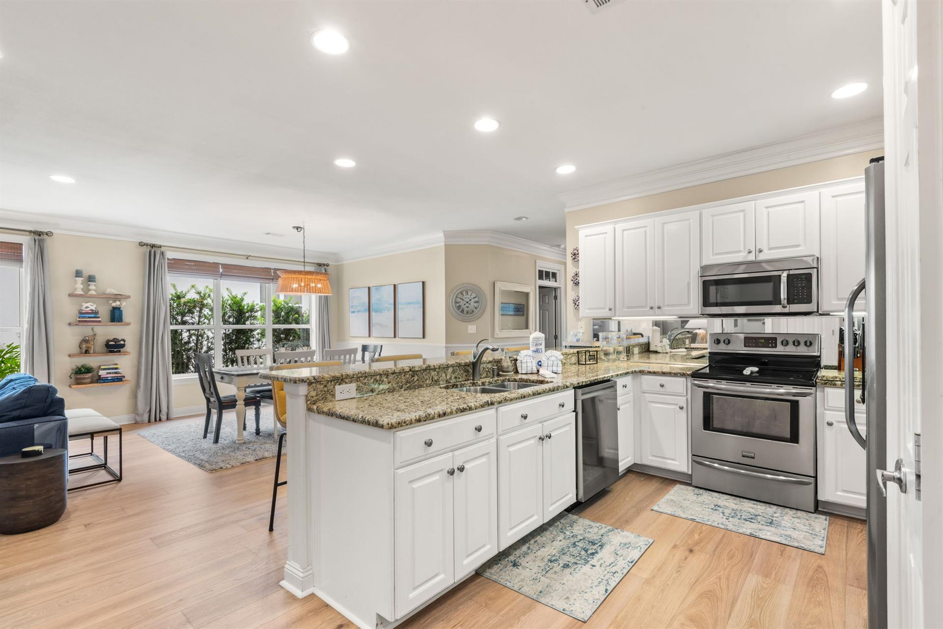 The bright, openconcept kitchen flows seamlessly into the dining and living spaces, perfect for gathering and creating memories.