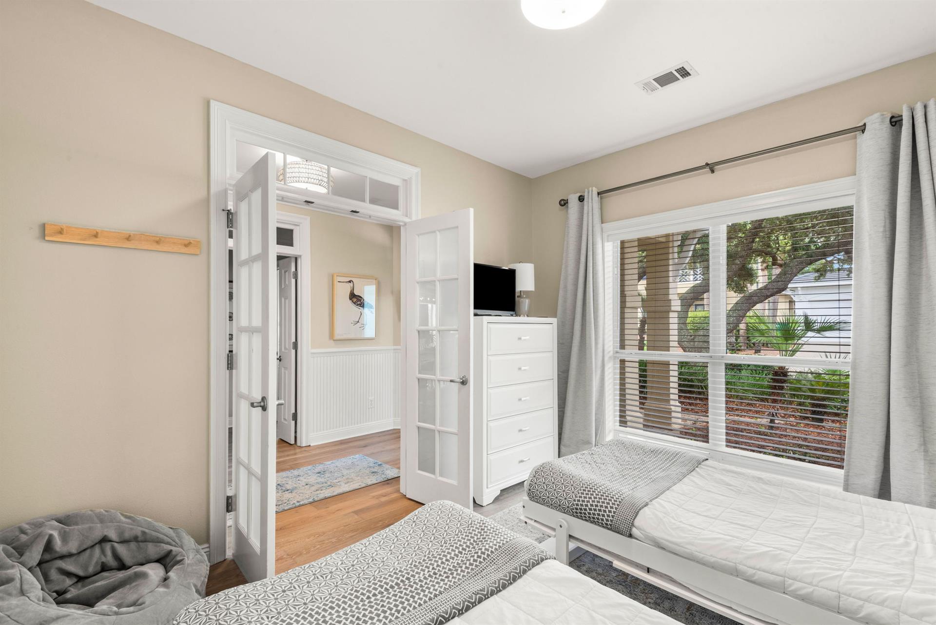 Youll love how the soft morning light fills this peaceful bedroom, creating a serene space to unwind.