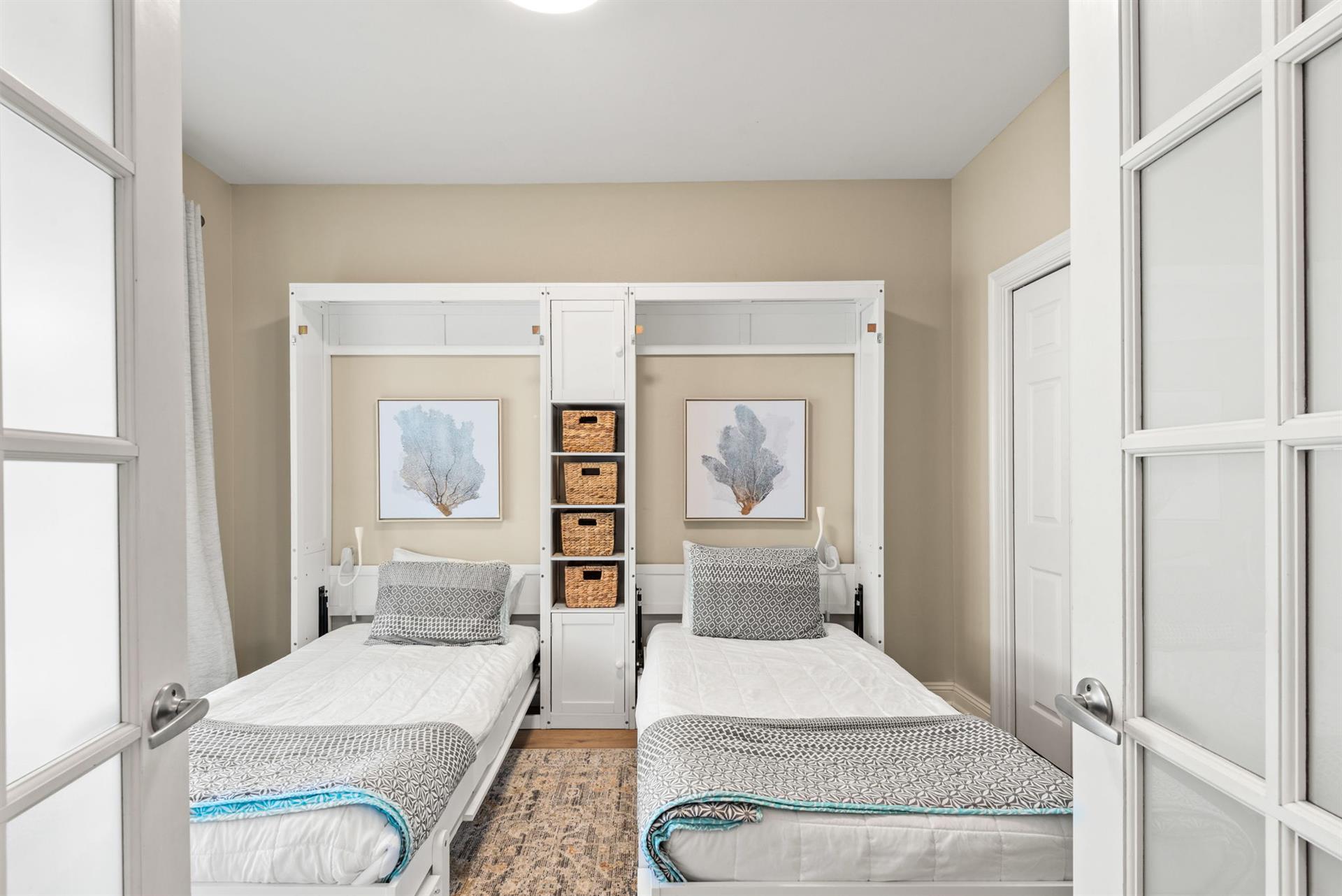 This perfectly appointed bedroom coastal artwork and a smart Murphy bed system—maximizing space without sacrificing style or comfort.