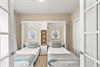 This perfectly appointed bedroom coastal artwork and a smart Murphy bed system—maximizing space without sacrificing style or comfort.