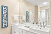 Start your day with ease in this spacious bathroom, featuring a double vanity, elegant countertops, and ample space to get ready in comfort.