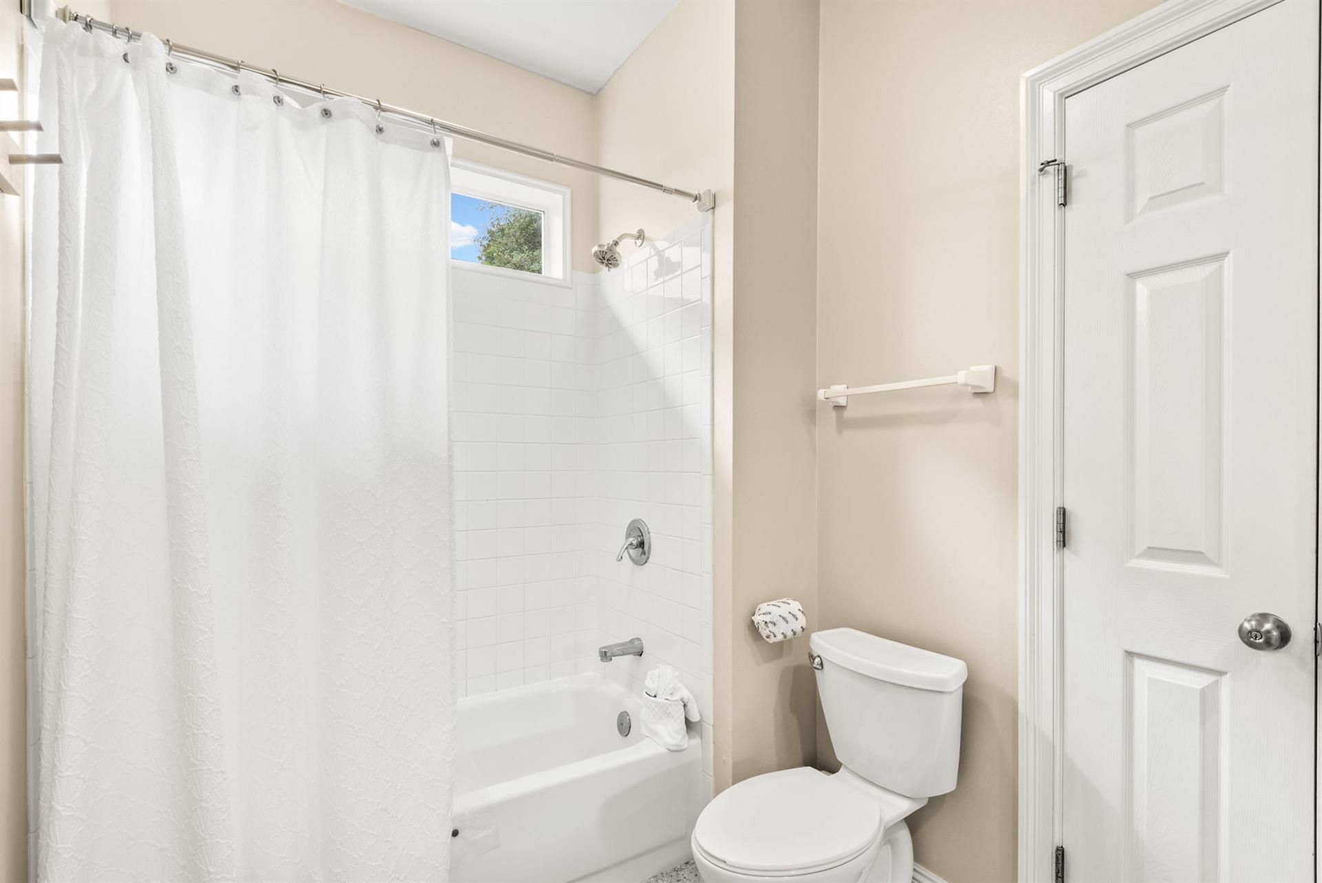 Refresh in your private bathroom with a full tubshower combo, and soft natural light streaming through the window.