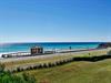 White sand, emerald waters, and a waterfront pavilion right across the street