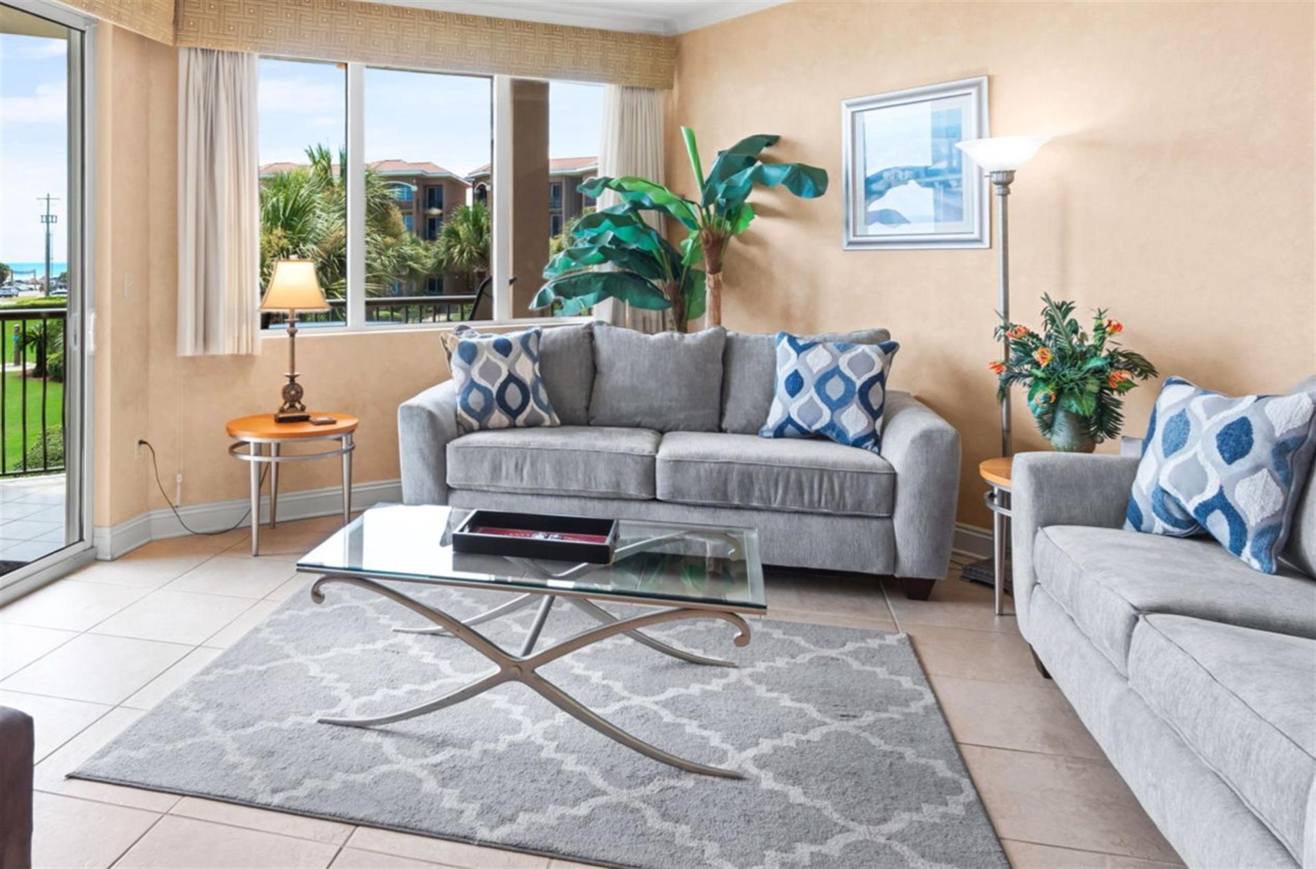 Unwind in the bright, coastalinspired living room with plush seating and balcony access.