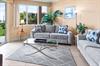 Unwind in the bright, coastalinspired living room with plush seating and balcony access.
