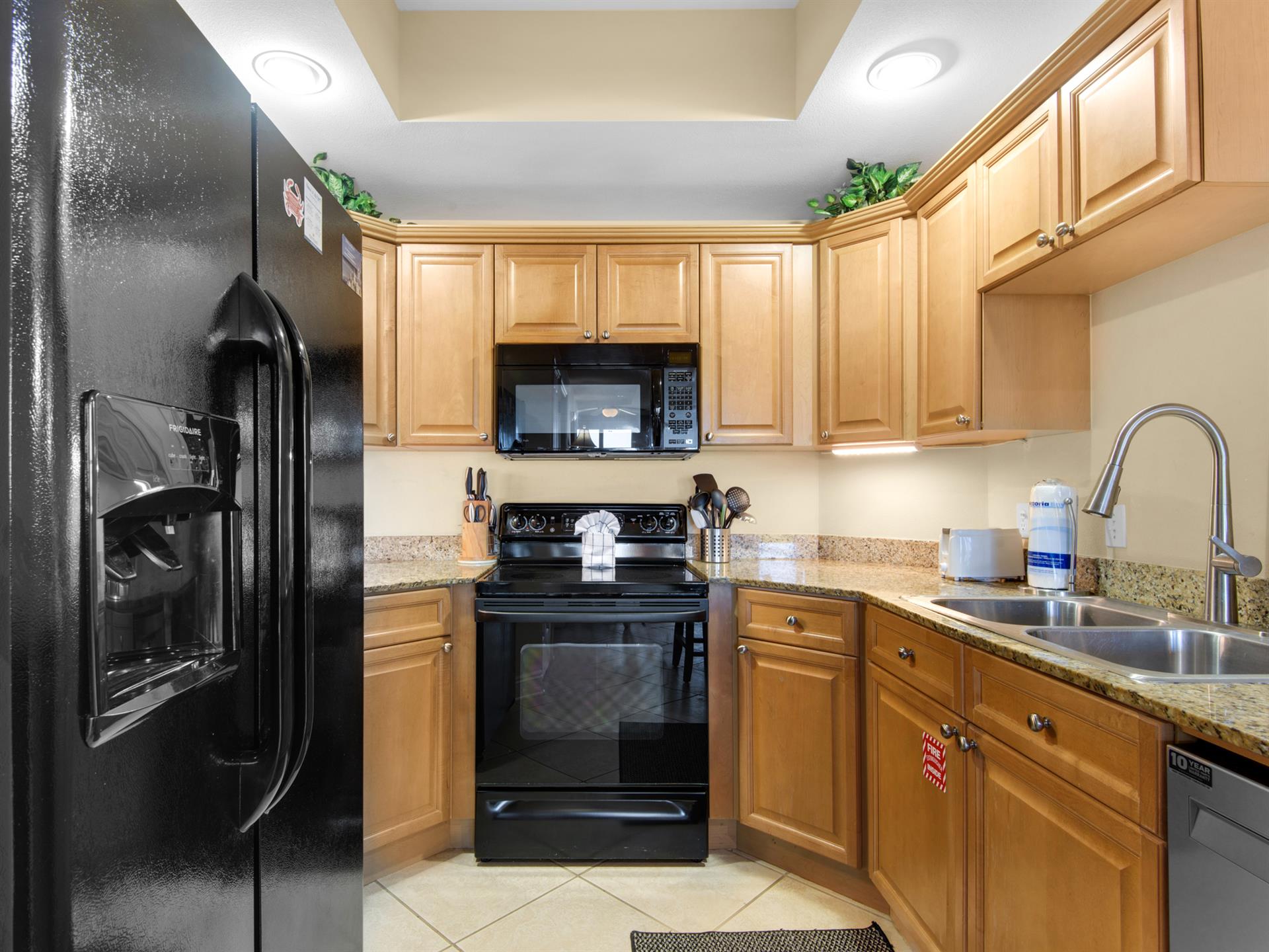The fully equipped kitchen features modern appliances and granite countertops