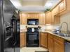 The fully equipped kitchen features modern appliances and granite countertops