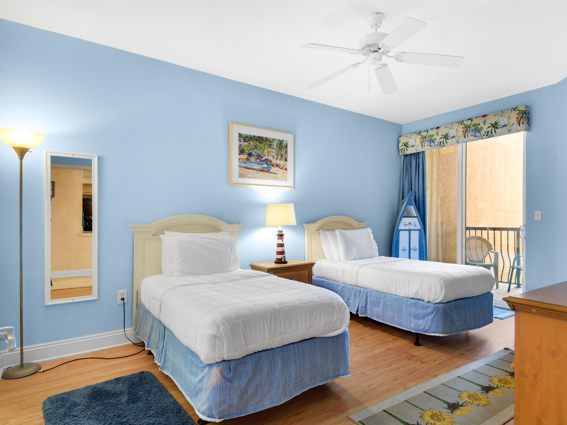 This coastalthemed retreat features two comfy twin beds with crisp white linens, and a soothing ceiling fan breeze.