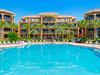 This vacation property features spacious balconies, tropical landscaping and a resort style pool  .