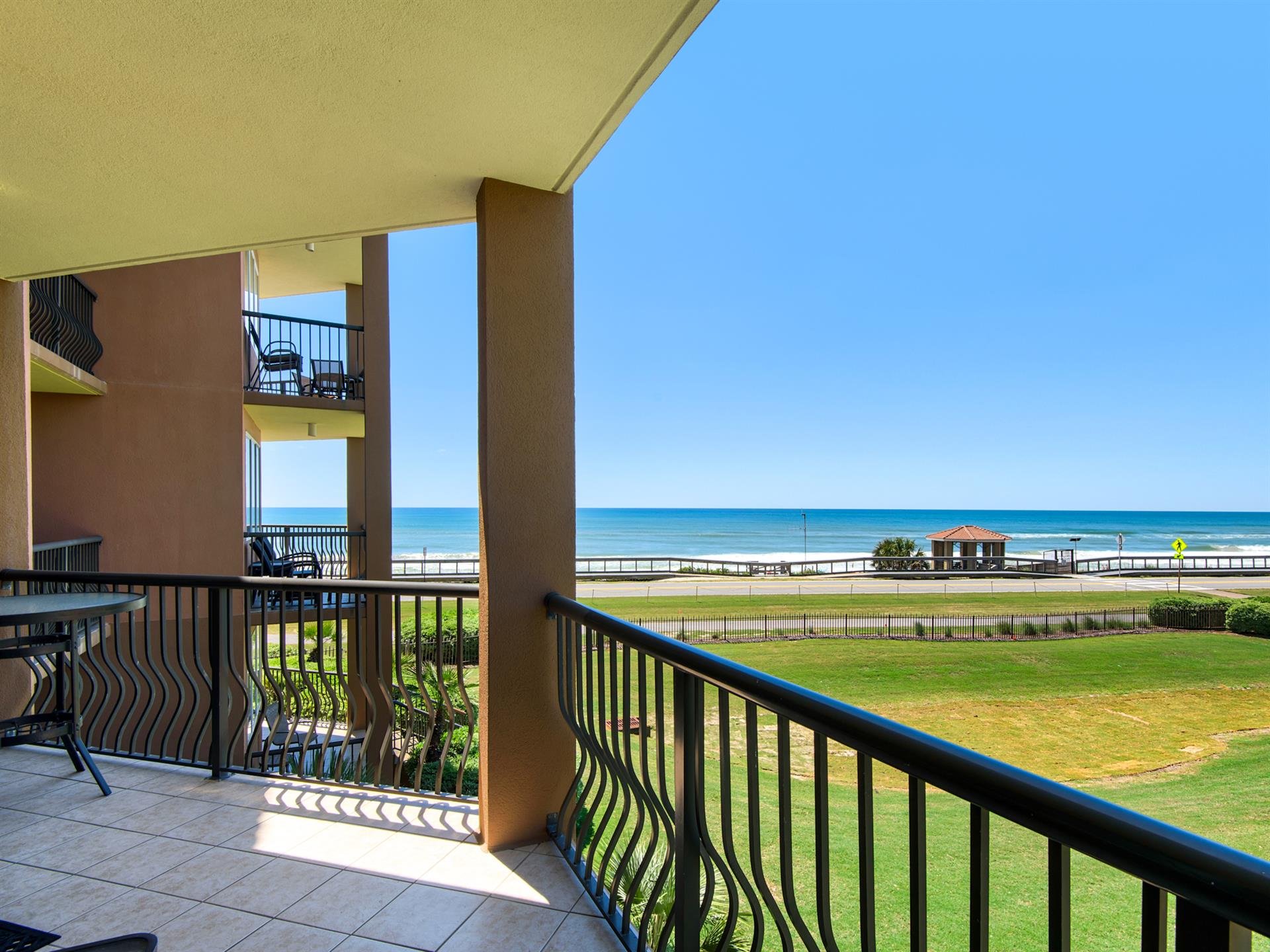 Beachfront property with direct ocean views and nearby beach access pavilion.