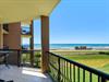 Beachfront property with direct ocean views and nearby beach access pavilion.