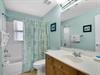 The guest bathroom features a full tubshower, and fresh towels.