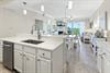 Your bright, open kitchen flows seamlessly into the living and dining areas, perfect for gathering and creating memories together. Soft pendant lighting, modern appliances, and calming coastal décor i