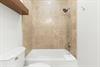 Step into your private bathroom featuring a tubshower combo with elegant beige tile, perfect for unwinding after a day of adventure.