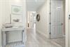 Step inside your serene coastal retreat, where whitewashed wood and nautical touches welcome you into a peaceful haven. The lightfilled hallway invites you to unwind and discover your home away from 