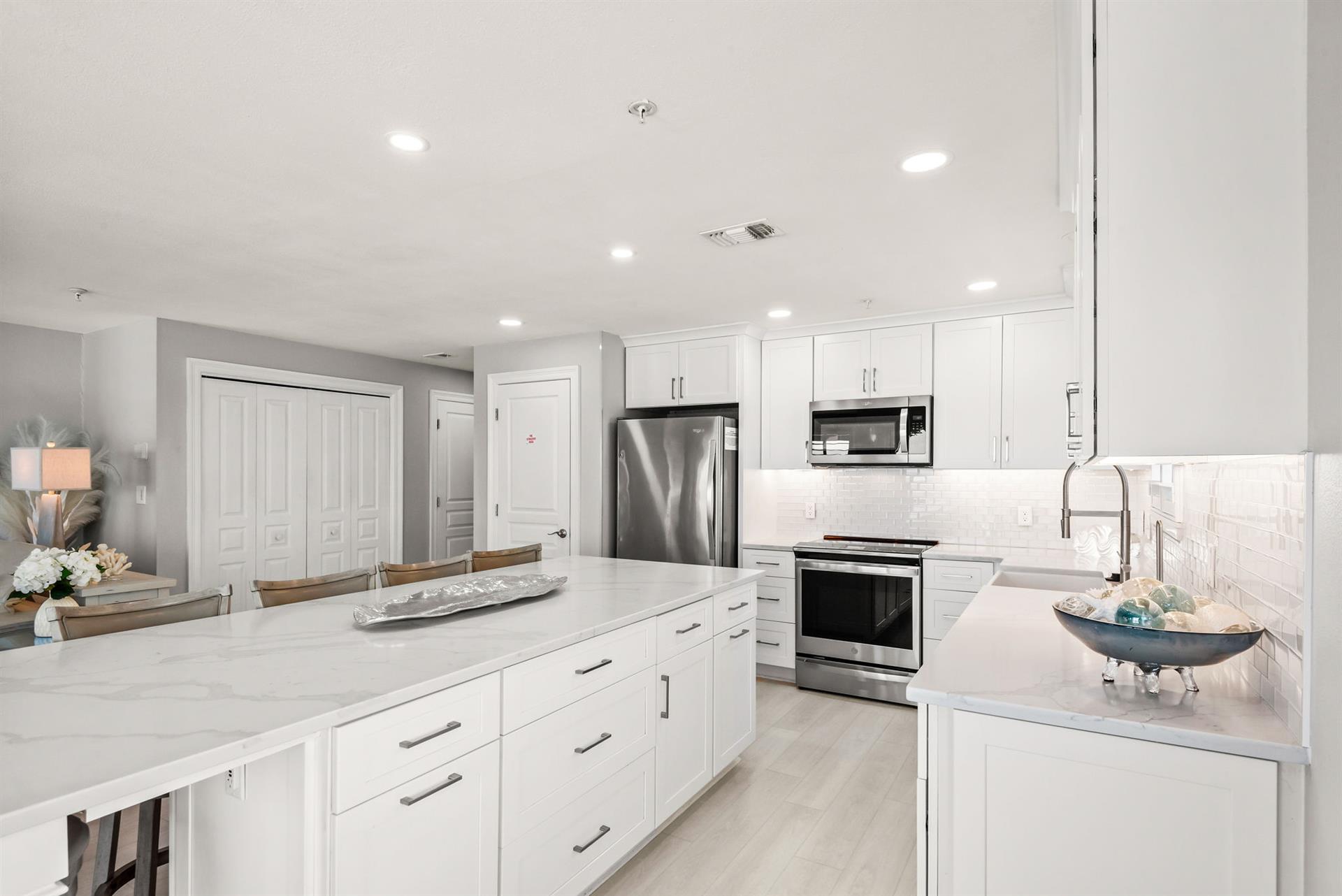 Your modern kitchen is designed for easy meal prep, with sleek white cabinetry and stainless appliances