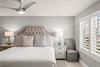 Unwind in this serene bedroom with plush bedding and elegant tufted headboard.