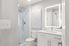 Bathroom 2 with a walkin glass shower and modern finishes.