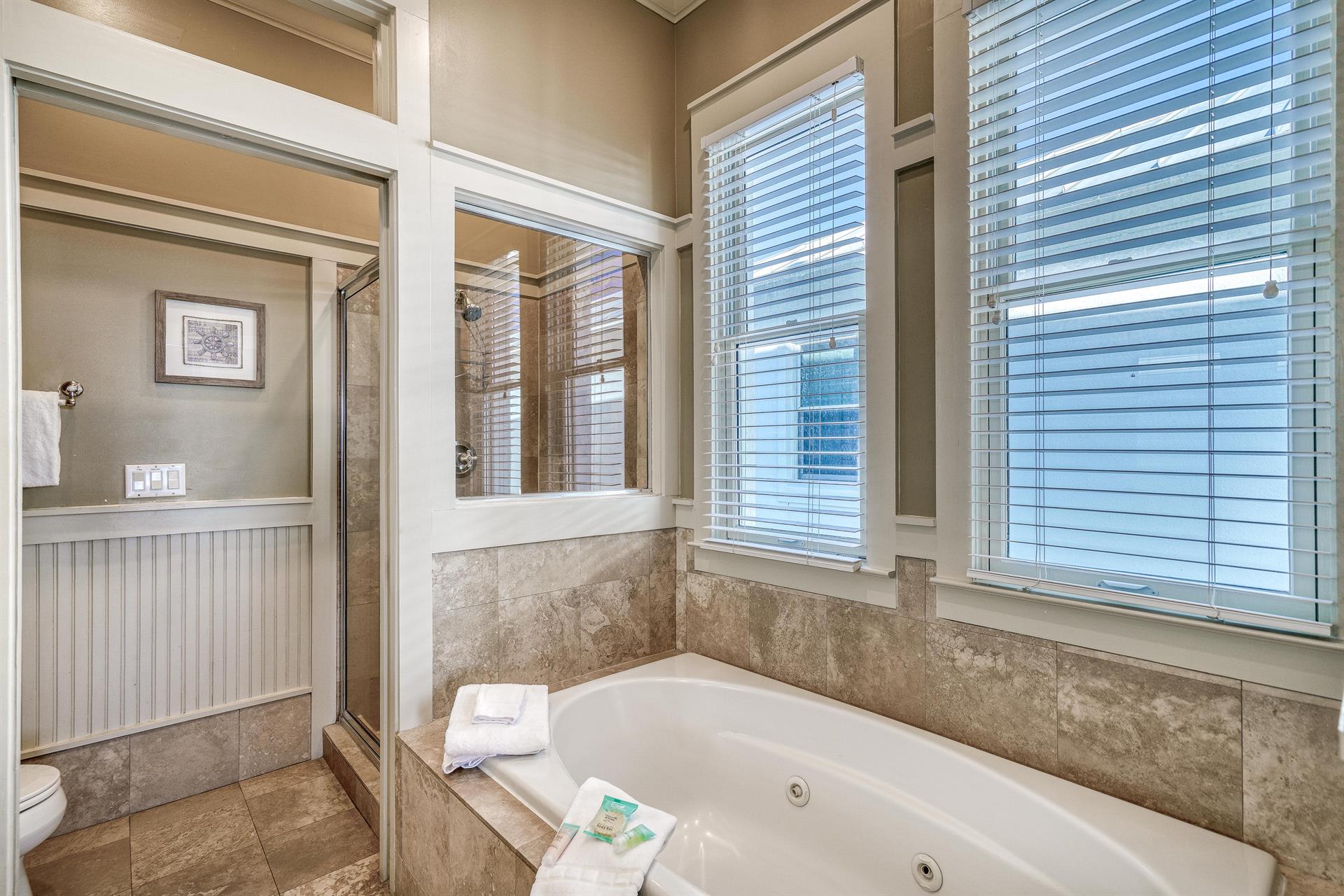 Primary ensuite bathroom with soaking bathtub  separate walkin shower