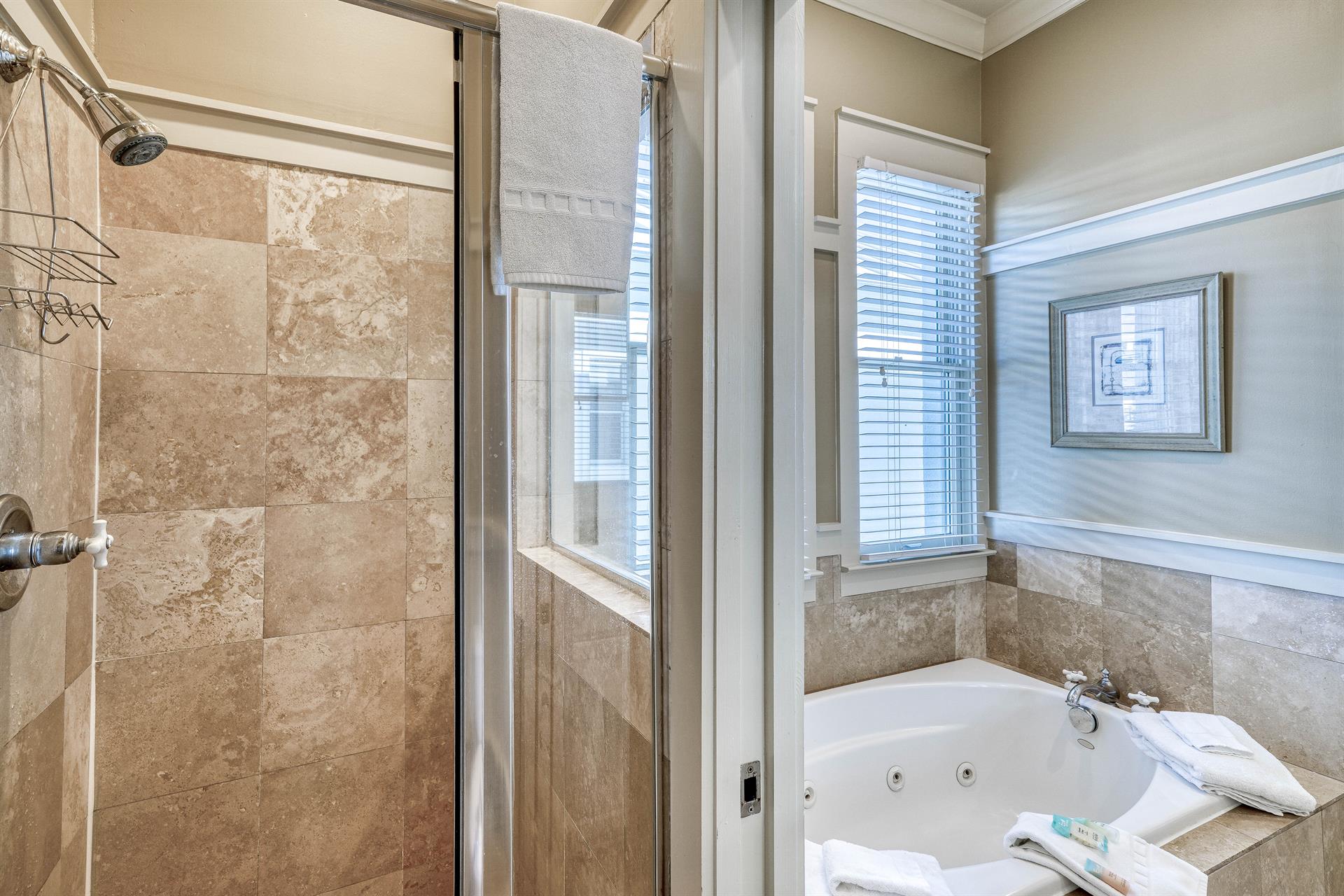 Travertine walkin shower in the primary ensuite.