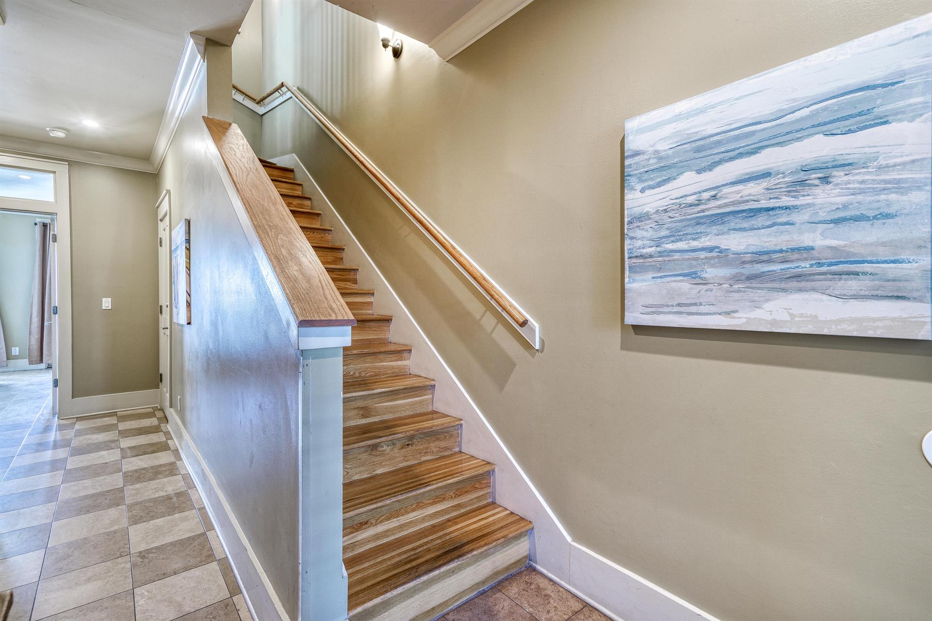 1st Floor Foyer with Whimsical Checkerboard Travertine Tile. Hardwood Floors on the Upper Floors