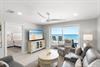 Step into your bright, open living space where plush seating and coastal breezes welcome you. Slide open the balcony doors and let the sound of waves become your soundtrack.