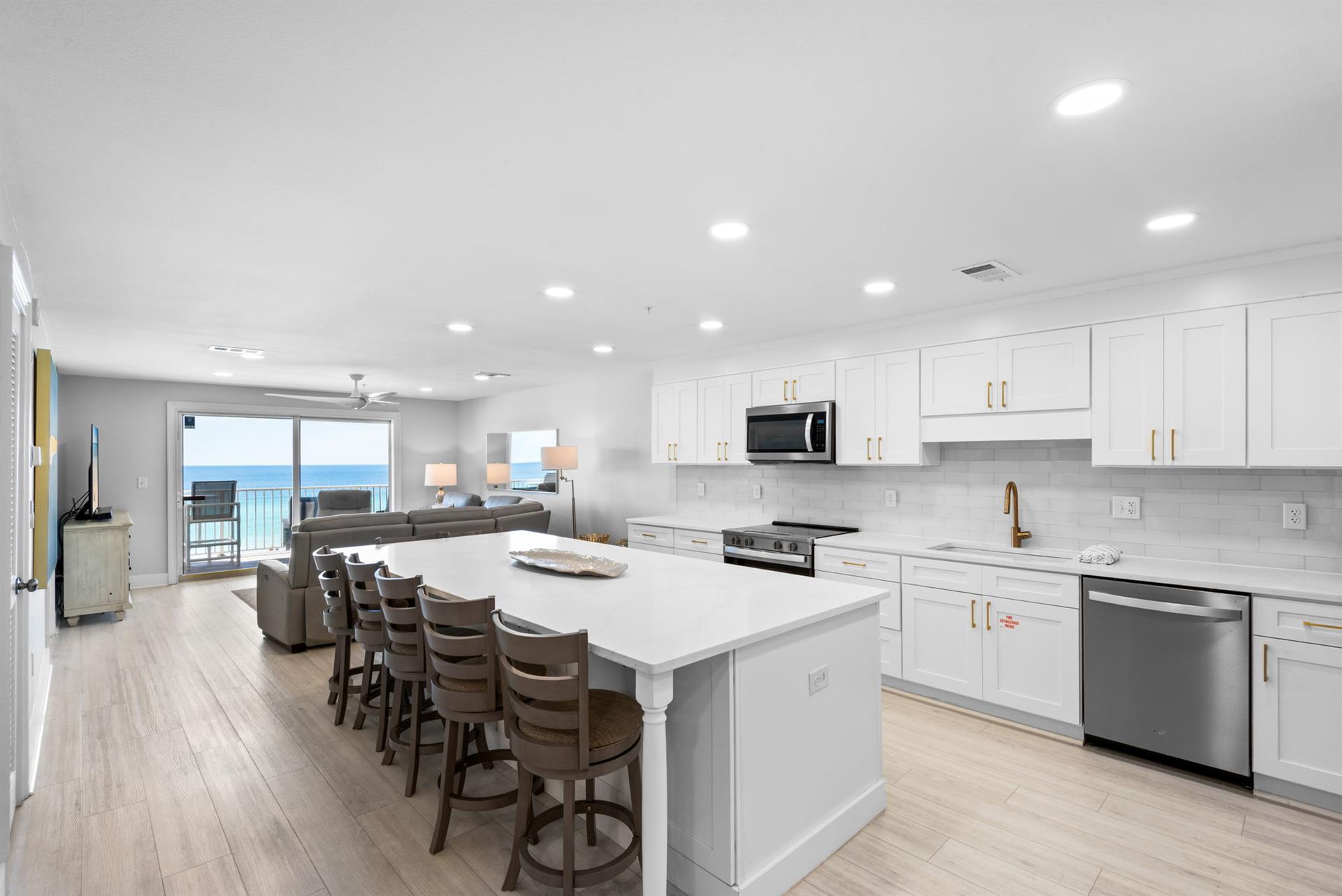 Picture yourself preparing meals in this bright, spacious kitchen while the ocean beckons just beyond the balcony doors—every moment here brings the beach within reach.