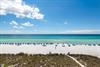 The property is located near a stunning beach featuring powdery white sand, turquoise waters, and colorful umbrellas dotting the shore—a perfect backdrop for your Gulf Coast getaway.
