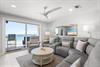 Sink into this inviting living room and let the ocean breezes drift through your balcony door. Soft seating and coastal details make this your perfect retreat after a day by the water.