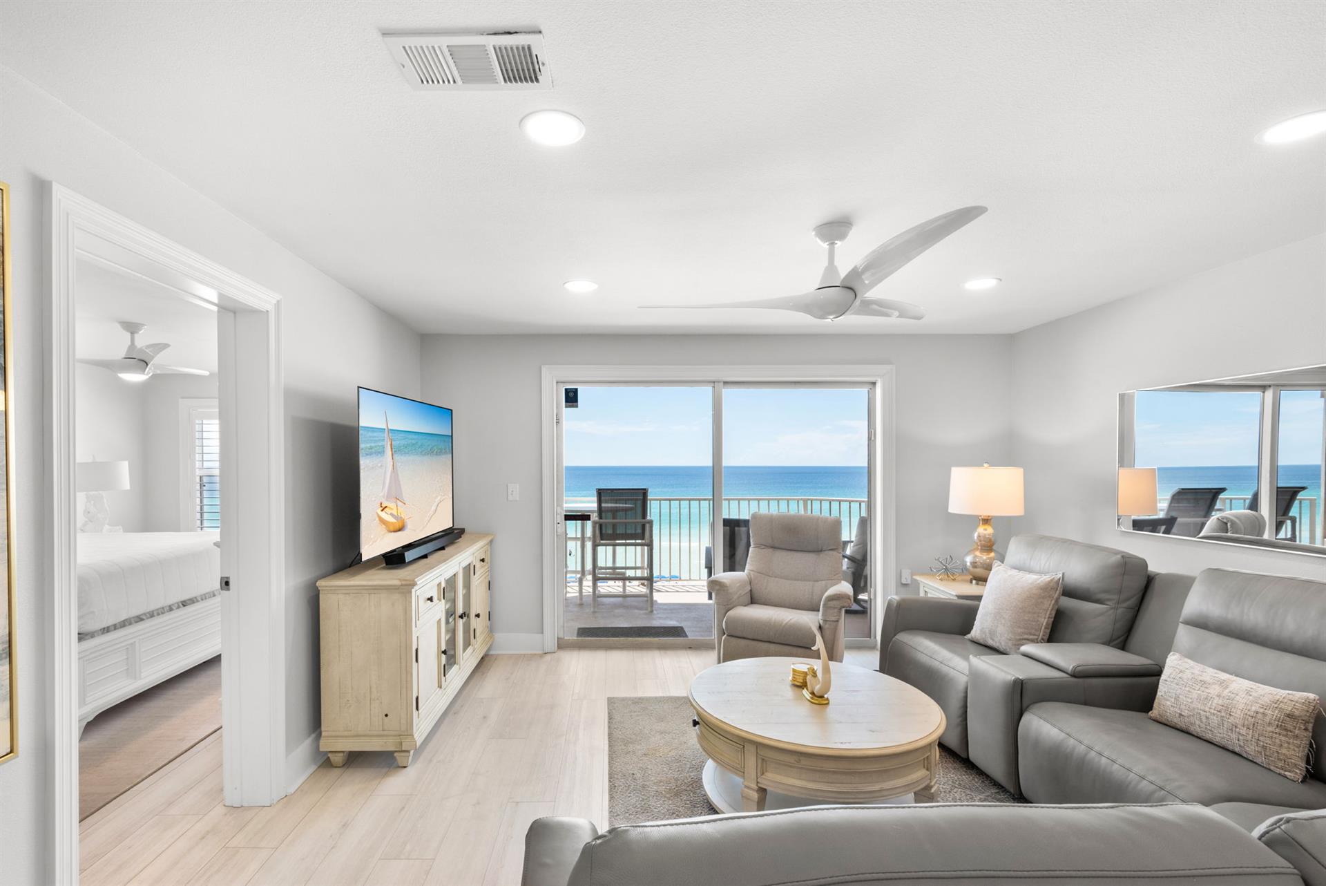Sink into the plush leather sofa and take in the stunning ocean view framing your balcony—your personal slice of coastal paradise.