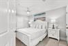 Unwind in your bright bedroom with crisp linens, coastal accents, and a ceiling fan to keep you cool and comfortable.