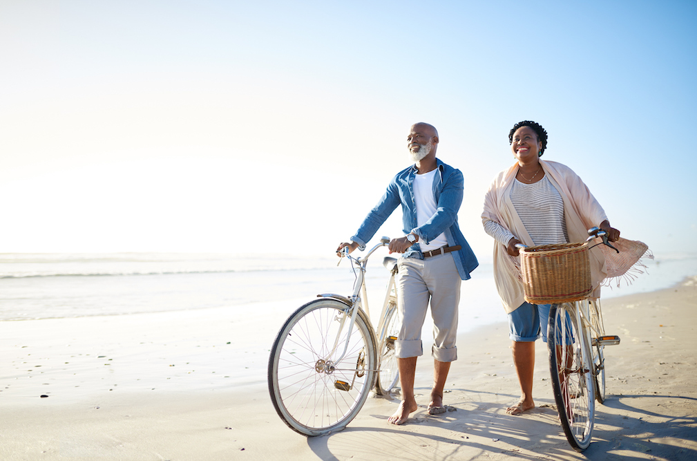 couple on the beach biking