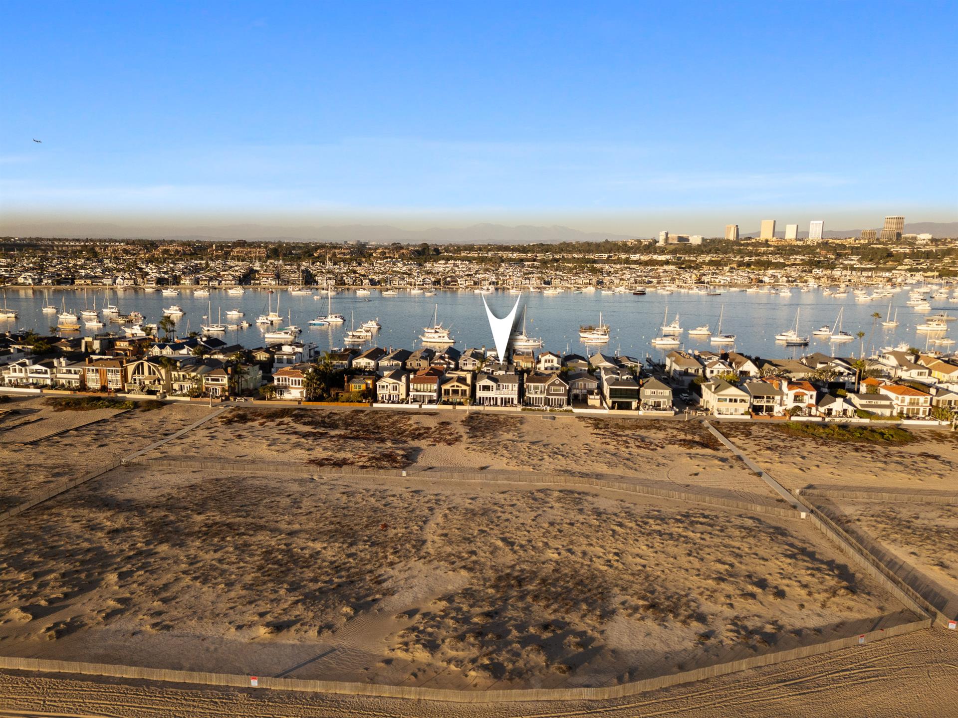 Aerial view of the beach with home pinpoint