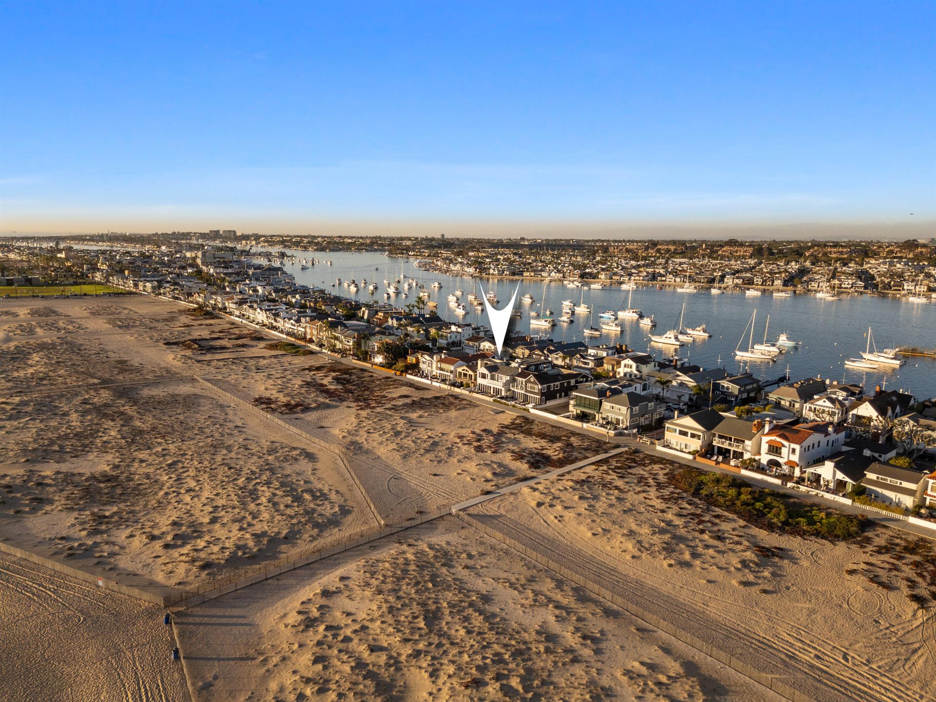 Aerial view of the beach with home pinpoint