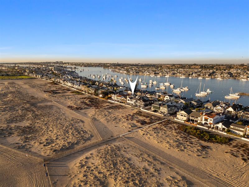 Aerial view of the beach with home pinpoint