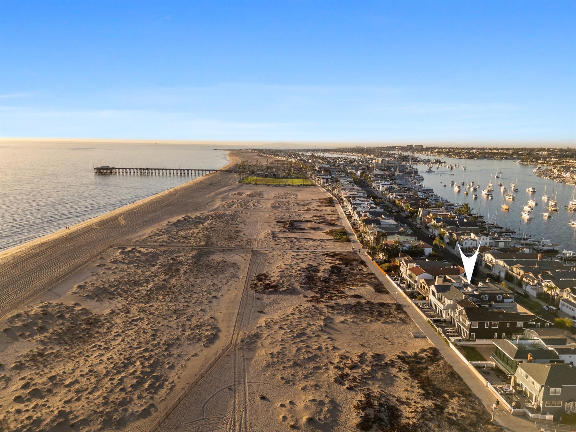 Aerial view of the beach with home pinpoint