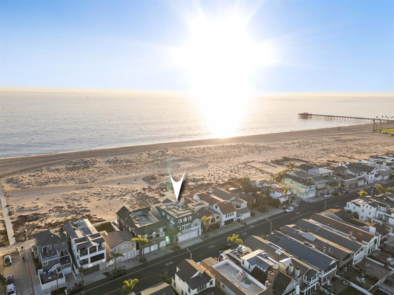 Aerial view of the beach with home pinpoint
