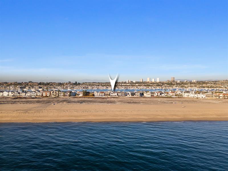 Aerial view of the beach with home pinpoint