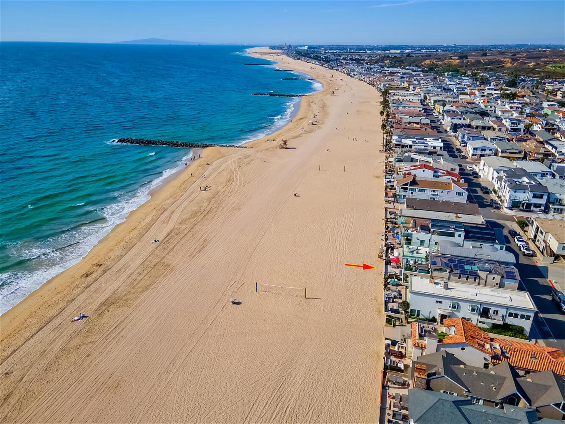 Aerial view of beach with home location pinpoint