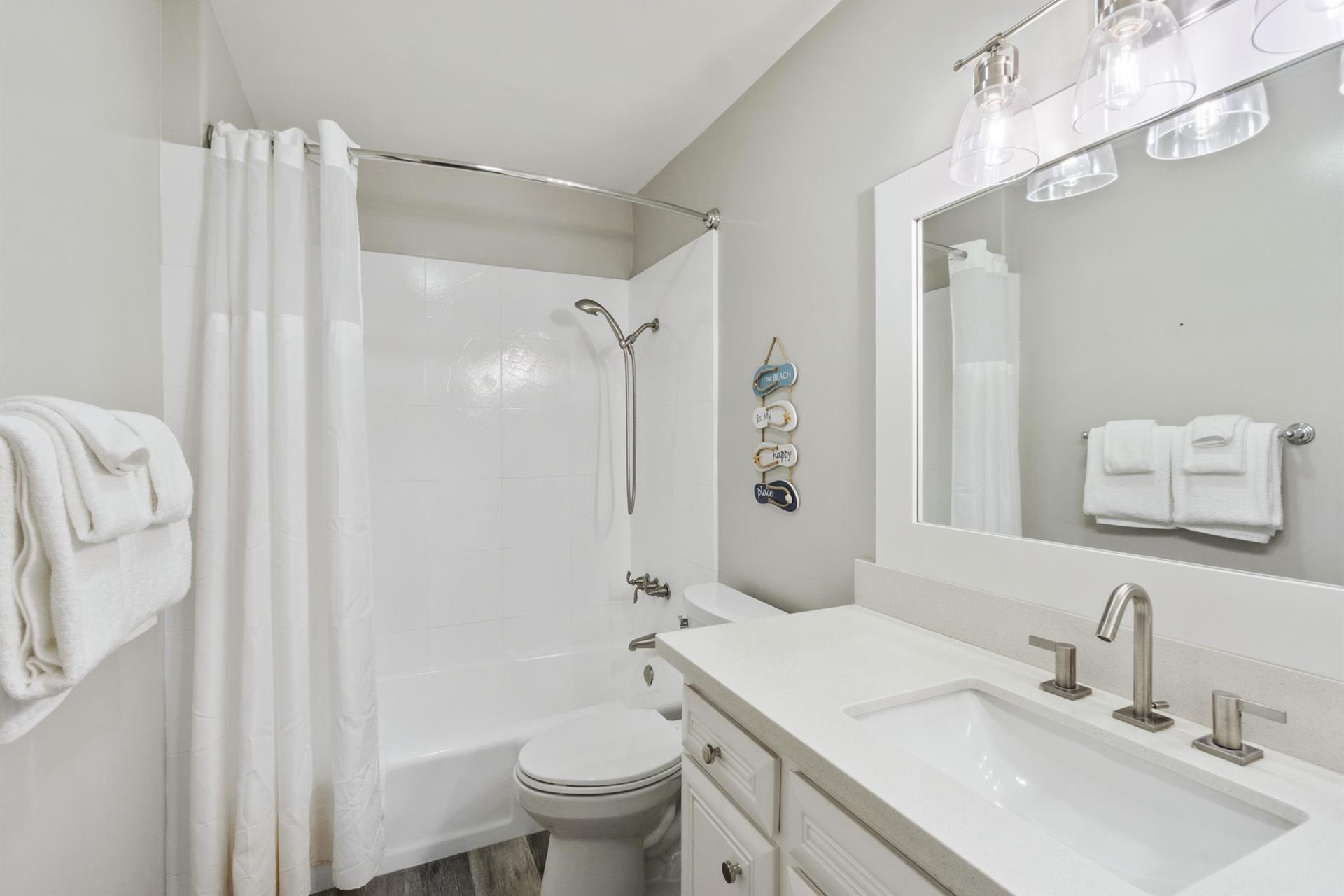 Ensuite secondary bathroom with private shower and tub