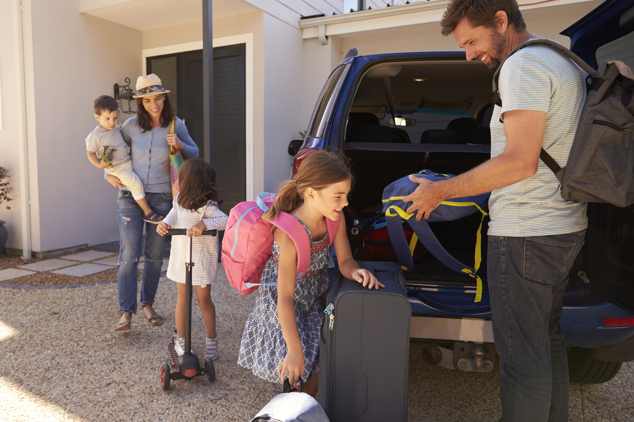family unloading car at vacation rental