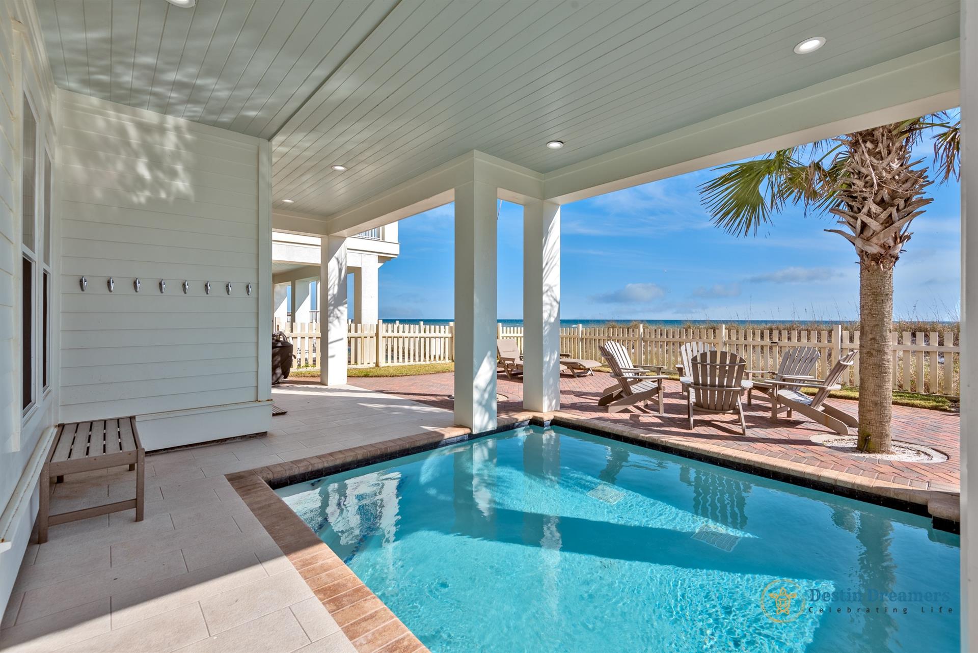 Heated, private pool with ocean views, outdoor seating, lounge chairs, and grill.